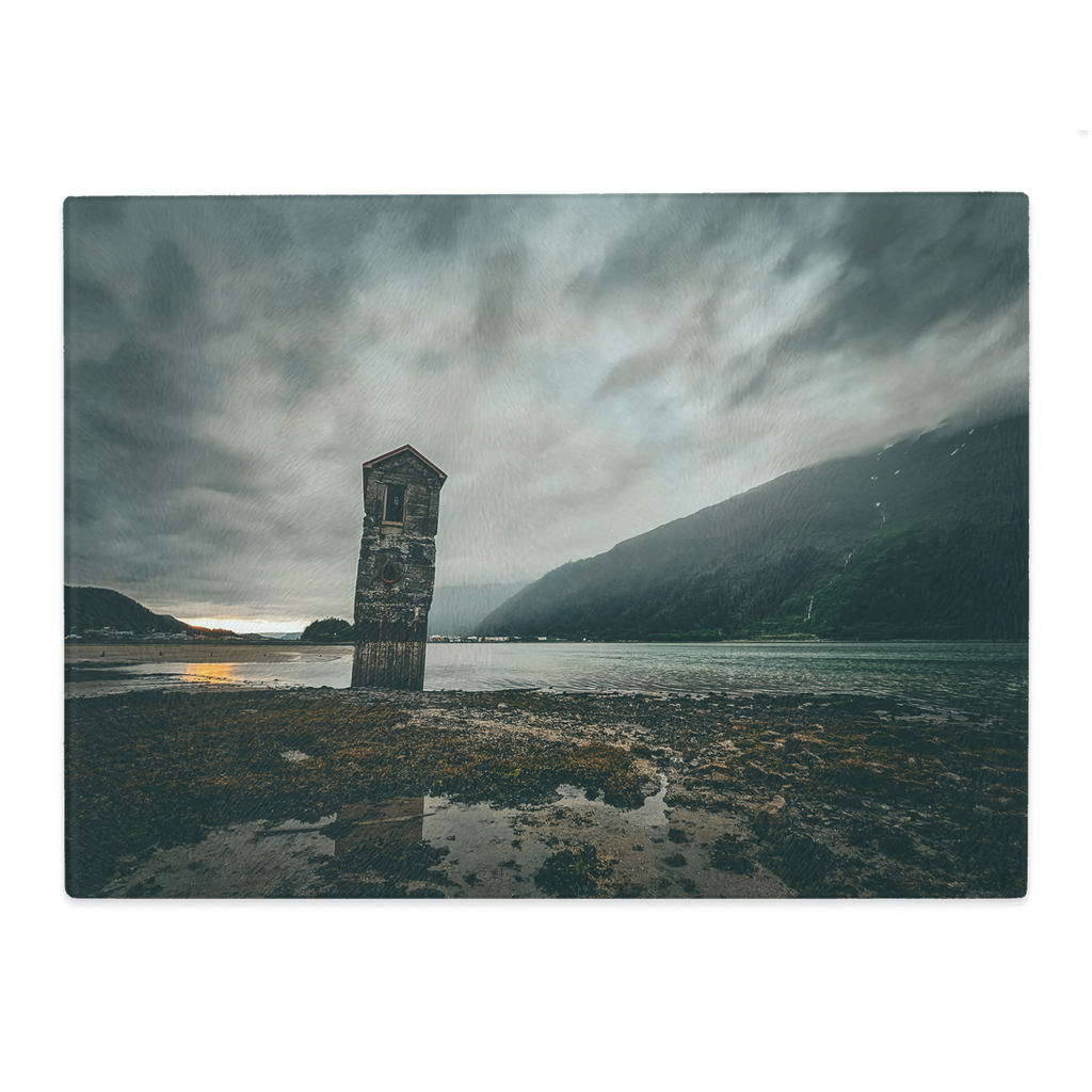 Sam Gilliss Visual Arts tempered glass cutting board and placemat featuring Stormy Sunset at Sandy Beach in Juneau, Alaska.