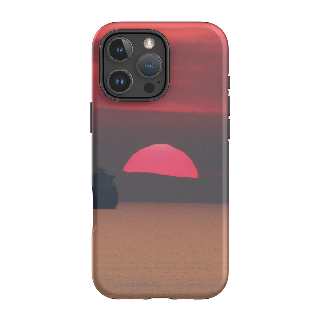 Premium cell phone case featuring Sam Gilliss Visual Arts' "Ship at Sunset, Corsica" artwork of a sunset over the Mediterranean coast.