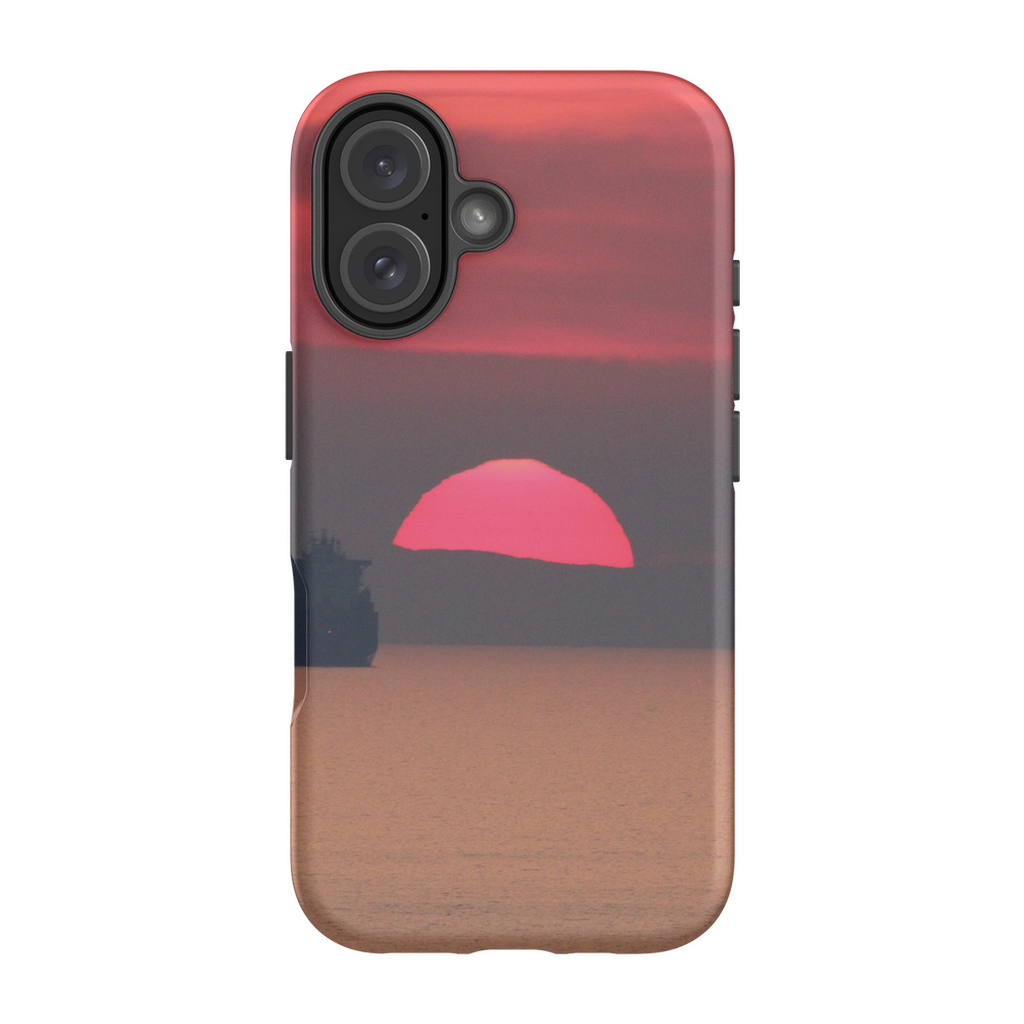 Premium cellphone case featuring Sam Gilliss' "Ship at Sunset, Corsica" artwork, showcasing a vibrant Mediterranean coast scene.