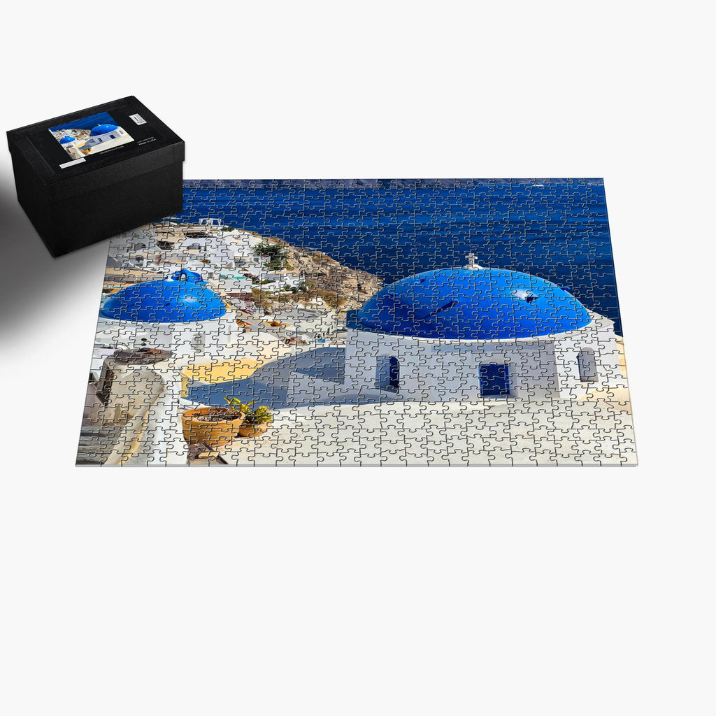 Jigsaw puzzle featuring Santorini Blue Domes by Sam Gilliss, showcasing Oia Greece's iconic blue-domed buildings in a colorful scene.