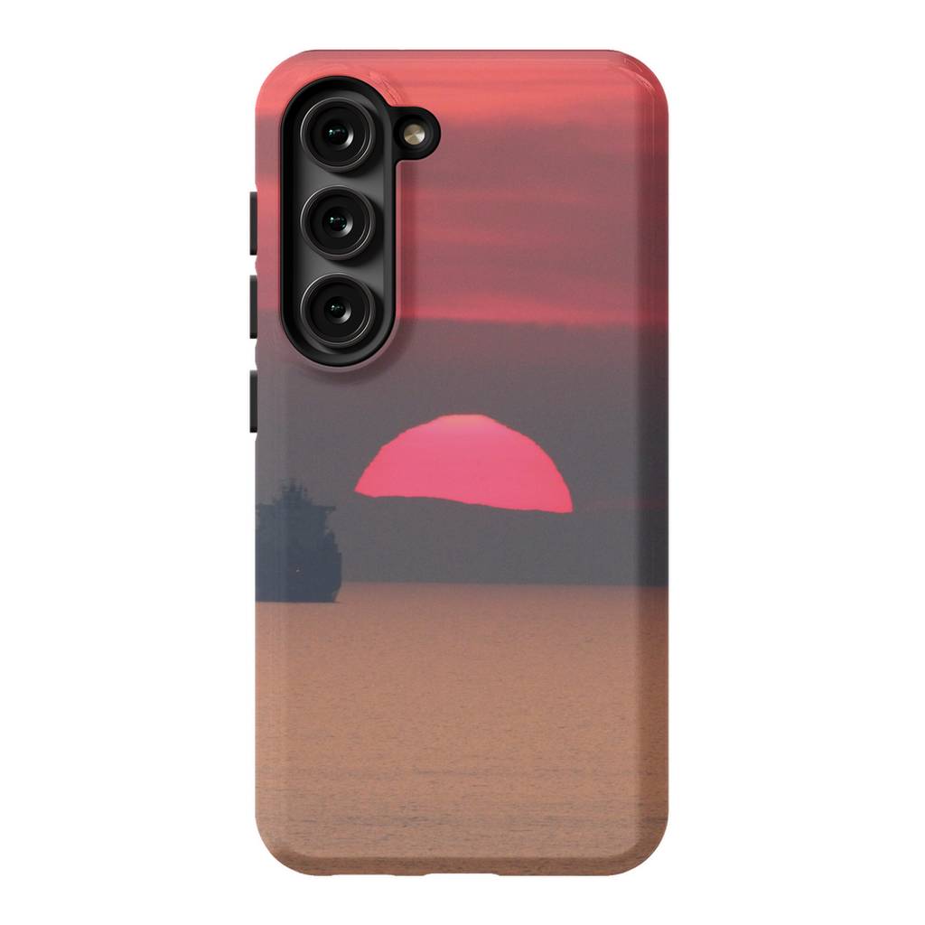 Premium cell phone case featuring Sam Gilliss Visual Arts' "Ship at Sunset, Corsica" artwork with Mediterranean coast scene.