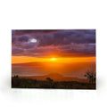 Sam Gilliss Visual Arts Keokea Sunset over the Ocean tempered glass cutting board and elegant placemat with vibrant sunset artwork.
